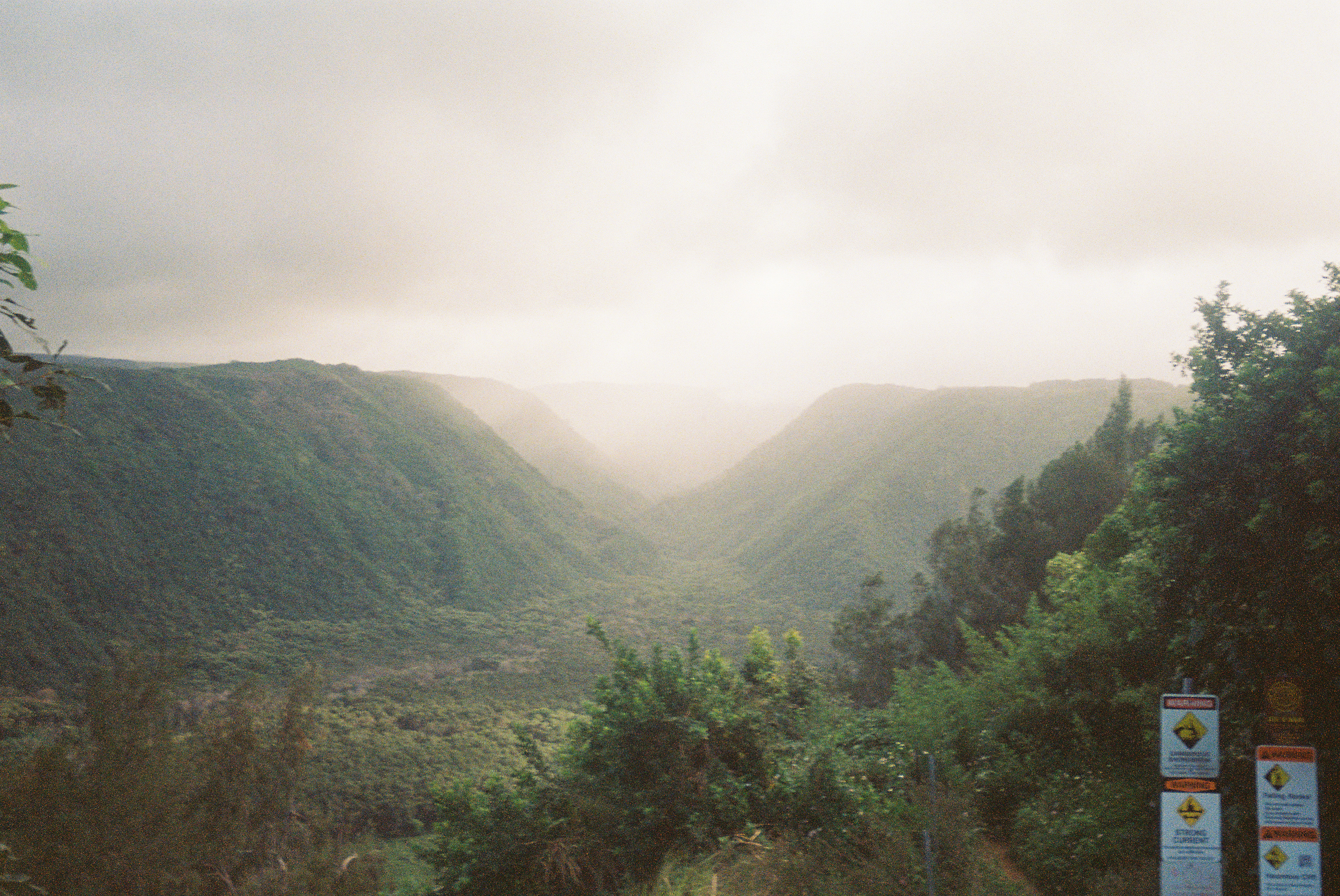 Misty green valley in Hawaii with clouds flowing through the mountains